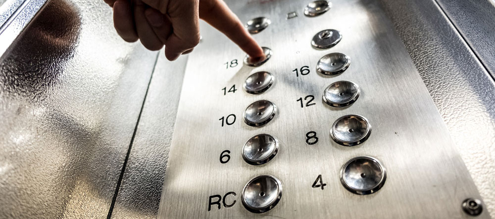 Sgt. Poopers can stop the transmission of germs in office settings. Image of finger pushing office elevator button